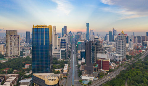 Aerial view of modern buildings in city against sky