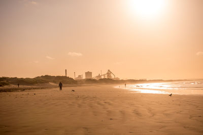 Scenic view of beach against sky during sunset