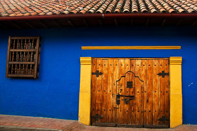 Closed door of blue house in town