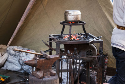 People working on barbecue grill