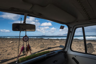 Close-up of dreamcatcher hanging in car