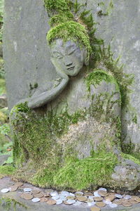 Statue against stone wall