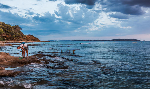 Scenic view of sea against cloudy sky