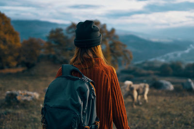 Rear view of woman looking at camera