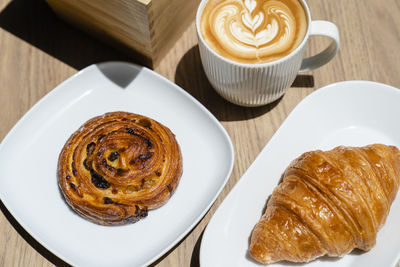 High angle view of cappuccino served on table