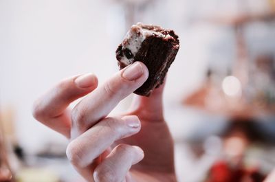 Close-up of cropped hand holding cigarette