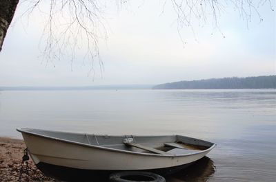Boat on the shore of the lake, minimalism. dormant nature