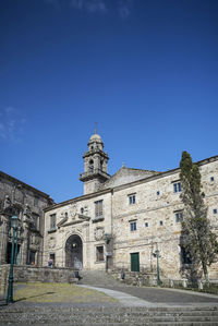 Low angle view of building against clear blue sky