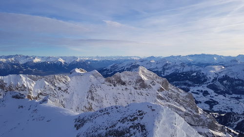 Scenic view of snowcapped mountains against sky during winter