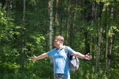 Male tourist auto stop spread his arms to the sides empty road.