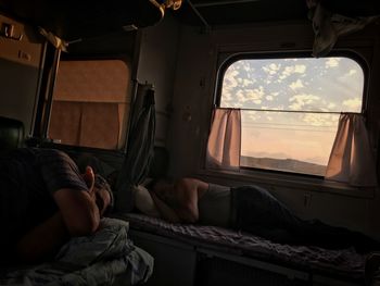 People resting in travel trainer during sunset