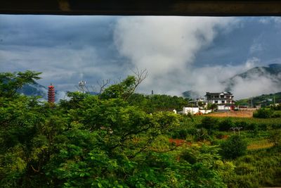 Panoramic view of trees and buildings against sky