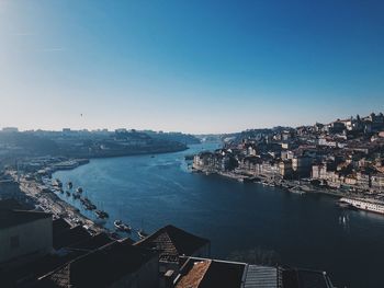 High angle view of buildings by sea against clear sky