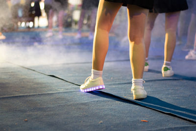 Low section of woman standing on street