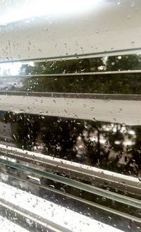 Road seen through wet window during rainy season