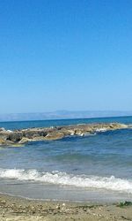 Scenic view of sea against clear blue sky