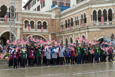 Group of people in front of building in city