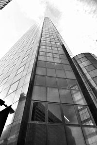 Low angle view of modern glass building against sky