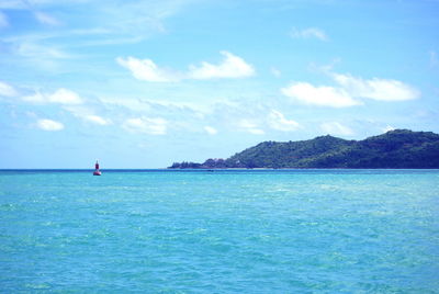 Scenic view of sea against blue sky