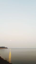 Scenic view of sea against clear sky during sunset