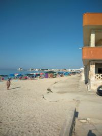 Scenic view of beach against clear blue sky