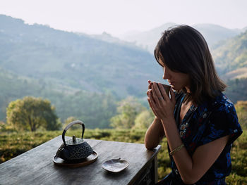 Woman drinking tea in garden