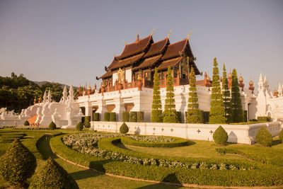 Panoramic view of historical building in garden against clear sky