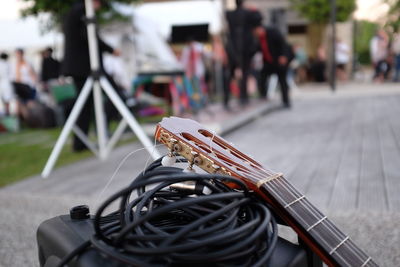 Close-up of electric guitar with cable on street