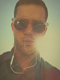 Close-up portrait of young man wearing sunglasses