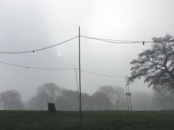 Scenic view of field against sky during foggy weather