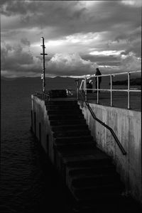View of jetty leading to sea