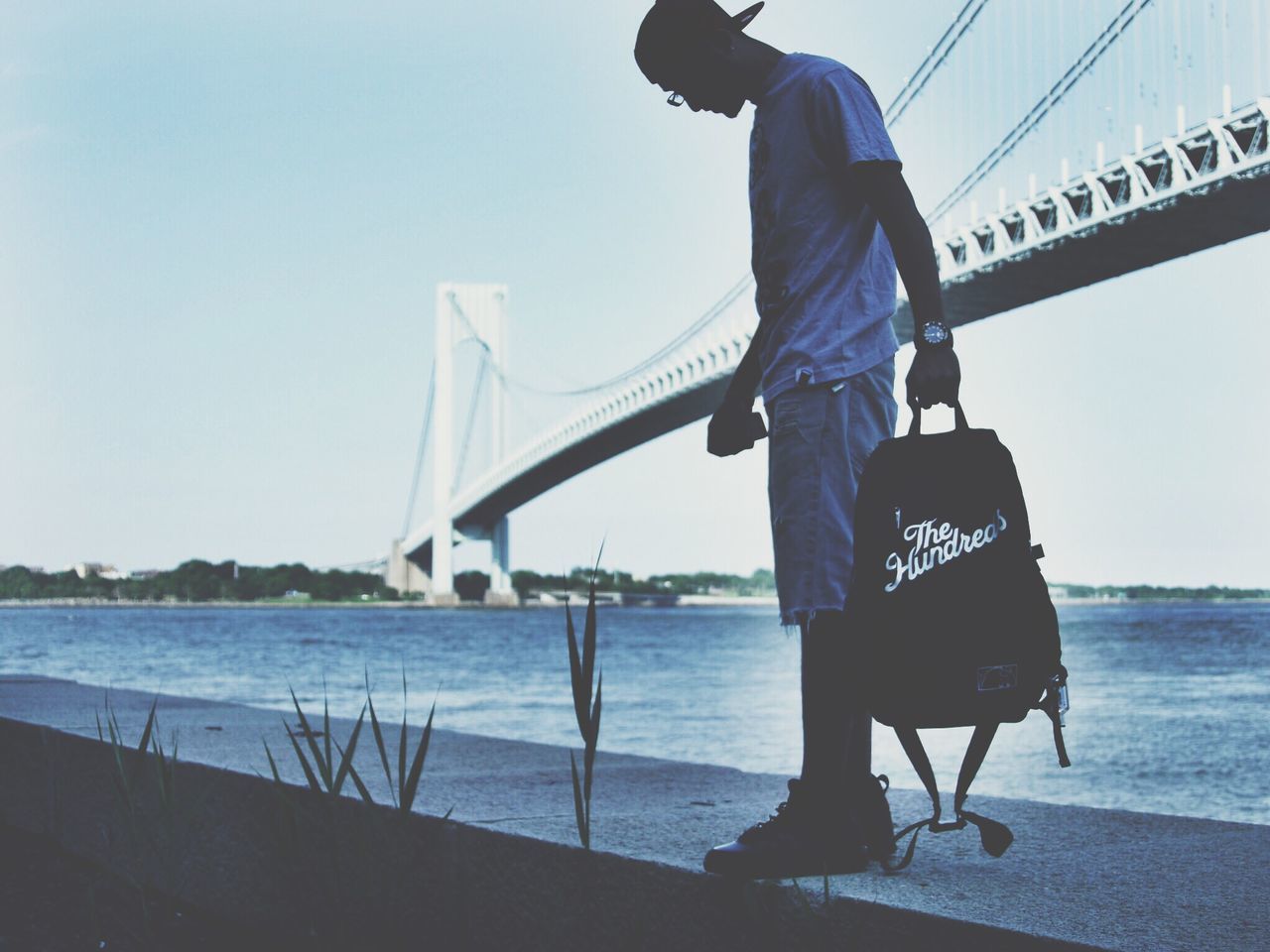 water, clear sky, sea, bridge - man made structure, connection, built structure, engineering, suspension bridge, architecture, tourism, lifestyles, travel, travel destinations, leisure activity, standing, men, transportation, rear view