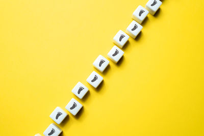 Close-up of toy blocks on yellow background