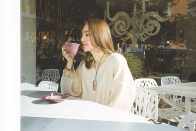 Woman standing by drink