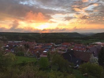 Aerial view of townscape against sky during sunset