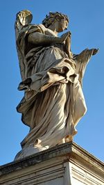 Low angle view of statue against clear blue sky