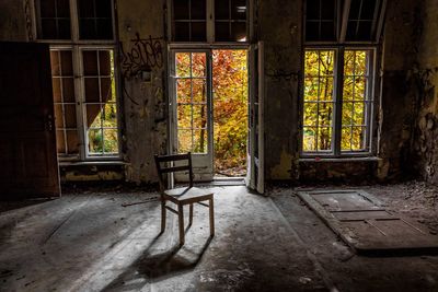 Empty chair in abandoned room