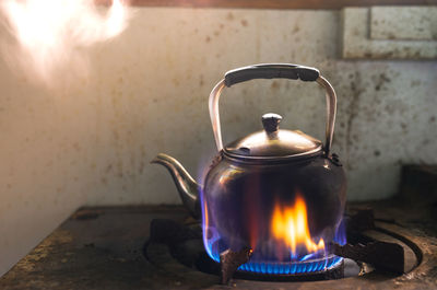 Close-up of kettle on stove in kitchen