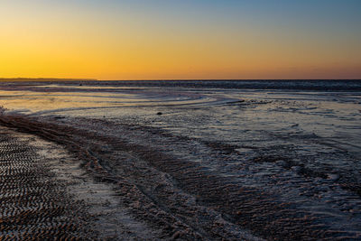 Scenic view of sea against clear sky during sunset