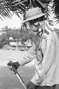 Close-up of senior man wearing hat standing in park