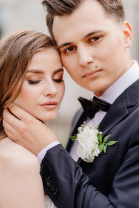 Portrait of couple embracing outdoors