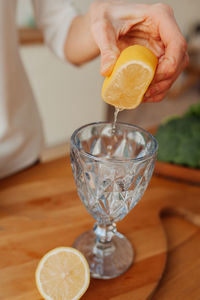 Close-up of hand holding glass of juice