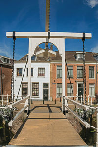 Bascule bridge over water canal and brick houses in weesp. a pleasant small village in netherlands.