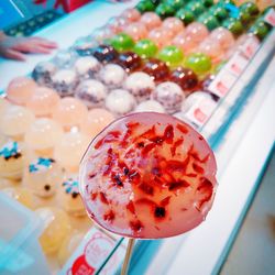 Close-up of lollipop with display cabinet in background at store