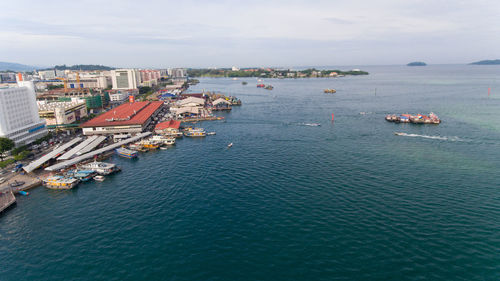 High angle view of sea and buildings against sky