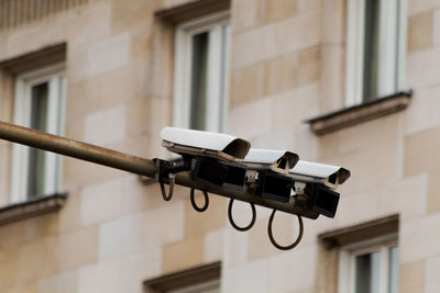 Low angle view of telephone pole against building