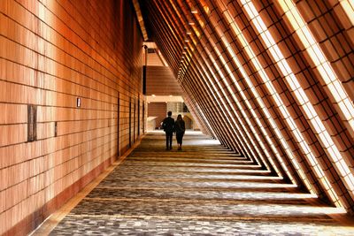 People walking inside corridor of building