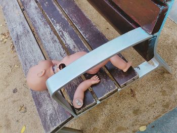 High angle view of toy on wooden bench