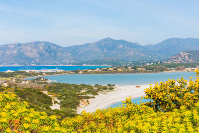 Scenic view of sea and mountains against sky