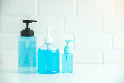 Close-up of bottles against blue background